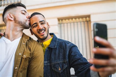 Free Photo Portrait Of Happy Gay Couple Spending Time Together And Taking A Selfie With Mobile