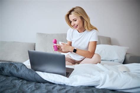 Beautiful Young Woman In Sleepwear Sitting On Bed And Talking On Video Call Stock Image Image
