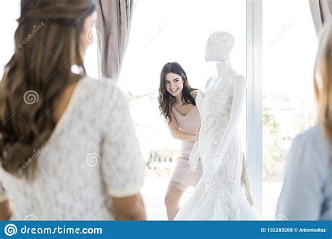 Noiva Que Olha Amigos Ao Estar Pelo Manequim Na Loja Foto De Stock