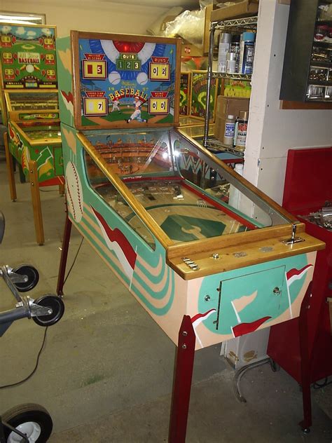 An Old Fashioned Pinball Machine In A Garage