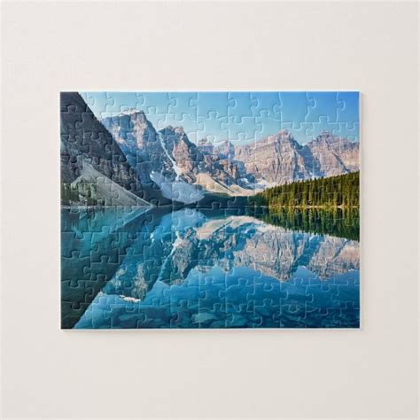 A Piece Of Jigsaw Puzzle With Mountains In The Background And Water