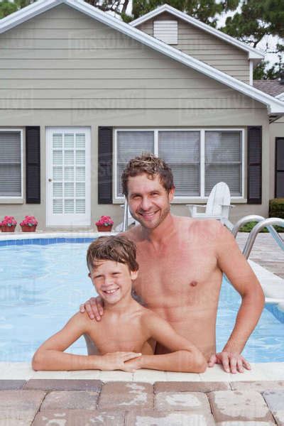 Father And Son Posing In Swimming Pool Stock Photo Dissolve