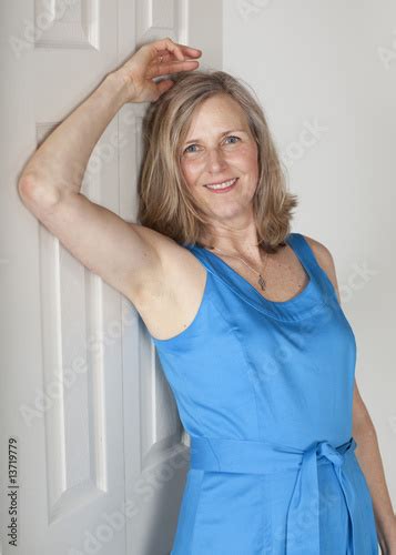 Attractive Middle Age Woman Leaning Against Door Stock Photo And