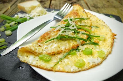 Take a bite and it's instantly savory, with a creamy interior and the perfect salty zing of cheese. Simple Cheese Omelette With Parmesan & Spring Onion - Raw ...