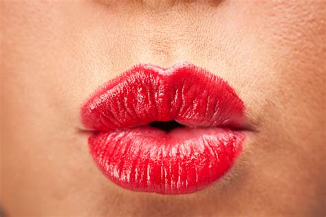 Women Blowing A Kiss With Bright Red Lipstick Stock Photo Download