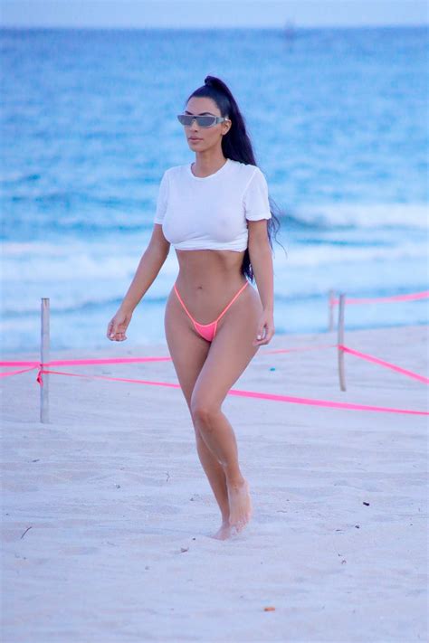 Kim Kardashian Sports A White Crop Top With Pink Bikini Bottoms During A Beach Photoshoot In