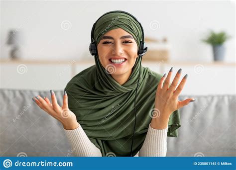 Happy Young Arab Woman In Hijab Speaking To Friend On Webcam Having