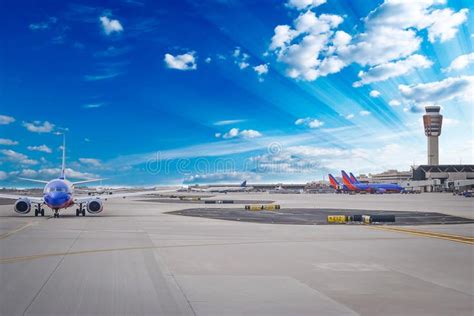 Airport Planes Departing At Busy Airport Terminal With Blue Sunny