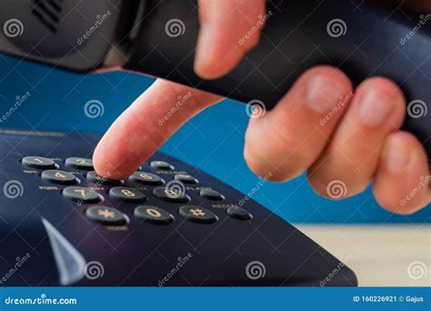 male hand holding telephone receiver dialing phone number stock image image of dialing