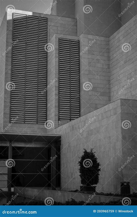 Vertical Greyscale Shot Of The Facade Of A Modern Building Stock Image