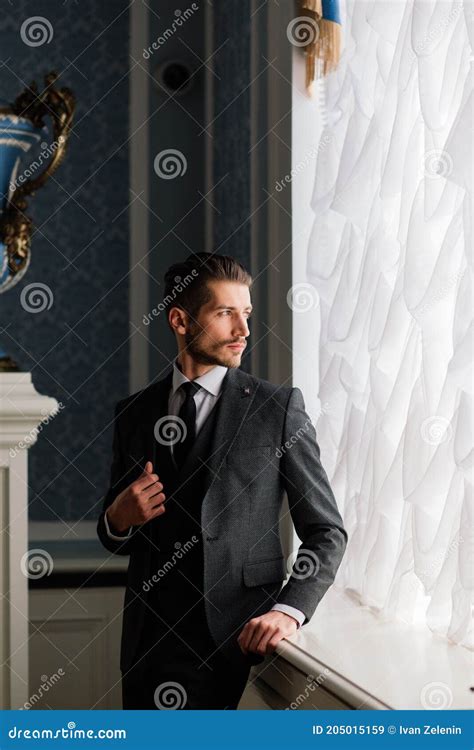Groom At Wedding Day Smiling And Waiting For Bride In Hall Of Hotel Elegant Rich Man In Costume