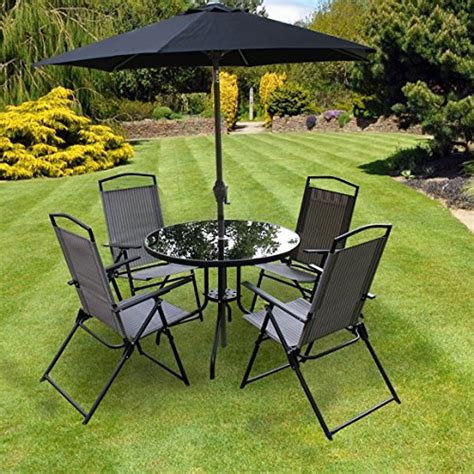 You can choose to host a lunch for your friends or just sit the parasol installation feature makes the furniture set even more usable. Kingfisher 6 Piece Grey Padded Chairs x4, Glass Table and ...