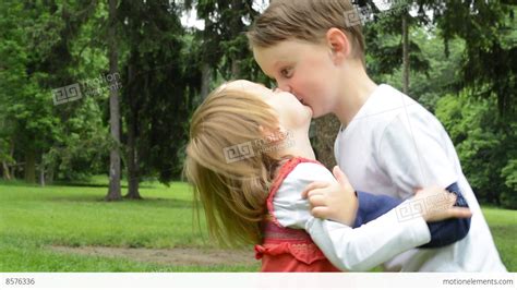 Children Siblings Boy And Girl Give A Kiss In Park Stock Video