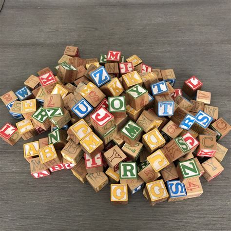 A Pile Of Wooden Blocks With Letters On Them