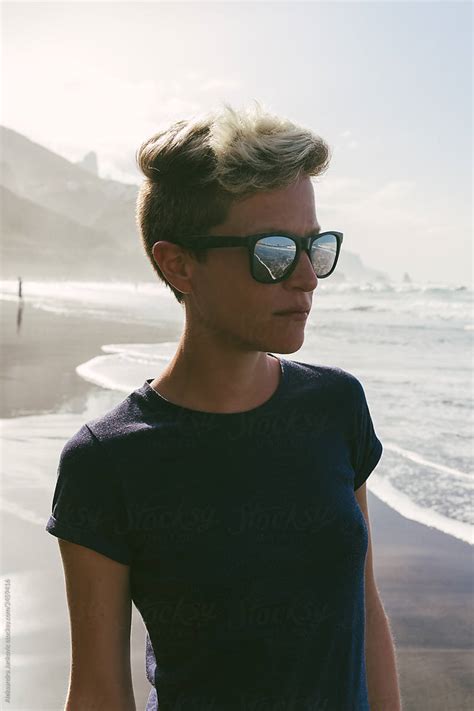 Stylish Short Haired Blond Woman Wearing Sunglasses At The Beach By