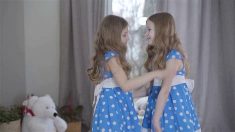 Side View Of Two Identical Sisters Having Stock Footage Sbv 338137301