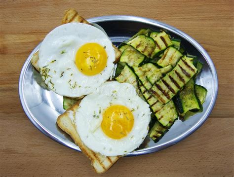 Two Fried Eggs With Grilled Zucchini And Toasted Bread Stock Image