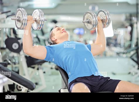 Young Muscular Man Lifting Weights In Gym Stock Photo Alamy