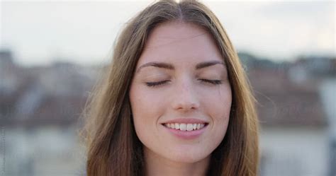 Close Up Portrait Of Beautiful Young Woman Smiling Hair Blowing In Wind