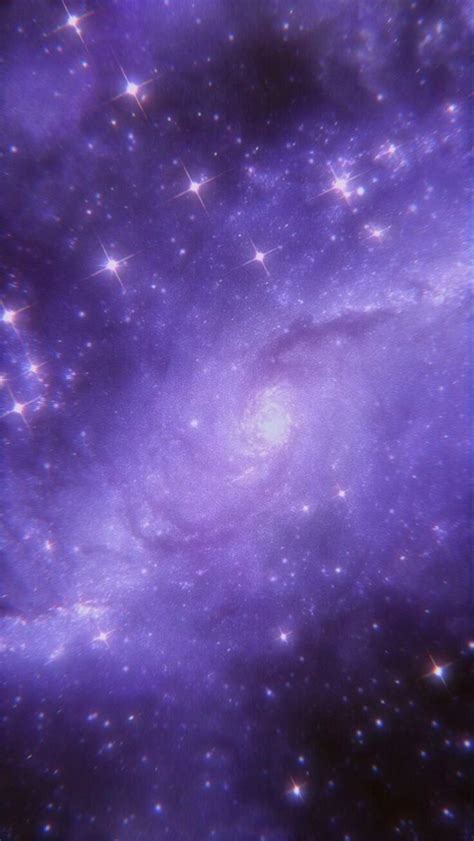 An Image Of A Purple Galaxy With Stars