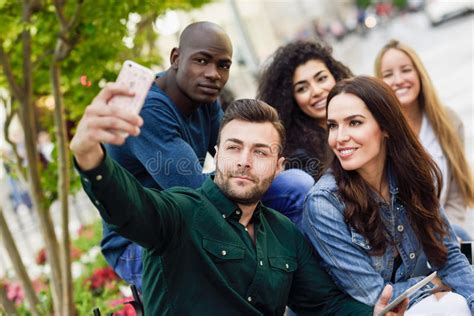 Multi Ethnic Young People Taking Selfie Together In Urban Background