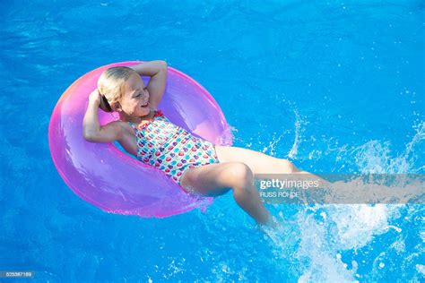 Girl Lying Back On Inflatable Ring In Garden Swimming Pool Photo