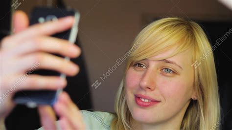 European Blonde Girl With Different Eyes Takes Selfie On Phone