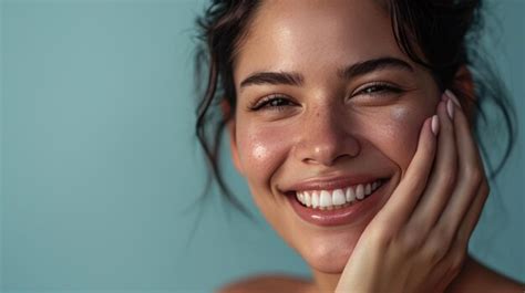 Premium Photo Smiling Woman With A Hand Gently Touching Her Face