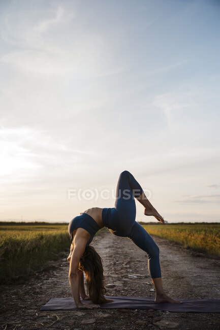 Woman Bending Over Backwards While Practicing Yoga — Barefoot Adults