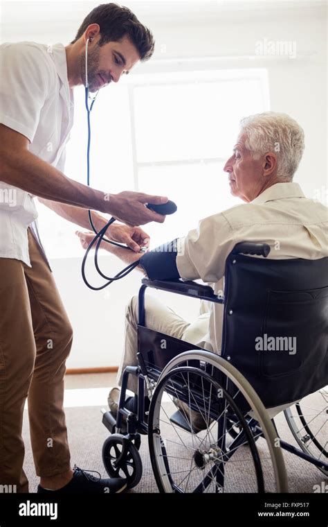 Nurse Measuring The Blood Pressure Of A Senior Man Stock Photo Alamy
