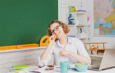 Female Teacher At Her Desk Marking Students Work Pretty Teacher