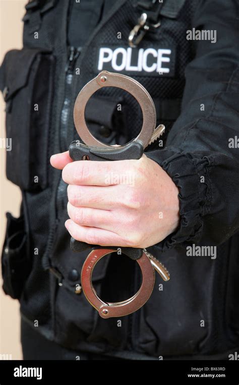 Police Officer Holding Handcuffs Stock Photo Alamy