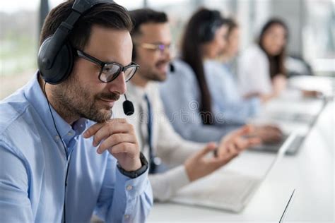 Close Up Head Shot Of Handsome Male Customer Support Agent With Headset