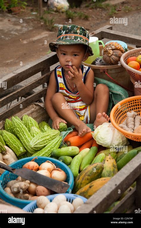 Small Boy Helps Mother Sell Vegetables From Kart Stock Photo Alamy