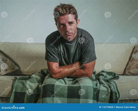 Young Sad And Desperate Man At Home Living Room Sitting At Sofa Couch