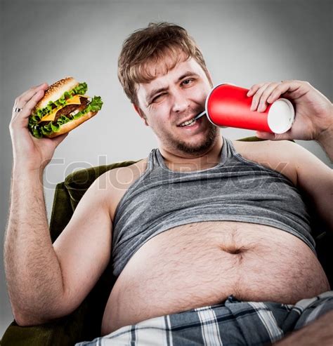 Fat Man Eating Hamburger Stock Photo Colourbox