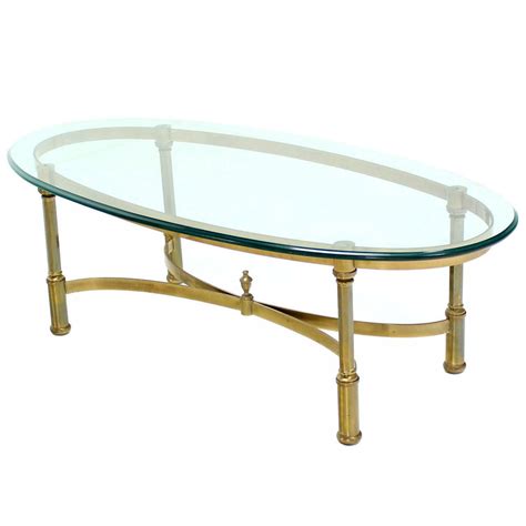 Glass coffee table comes with double shelves and irregularly boards. Oval Brass and Glass Coffee Table in Style of Jansen at ...