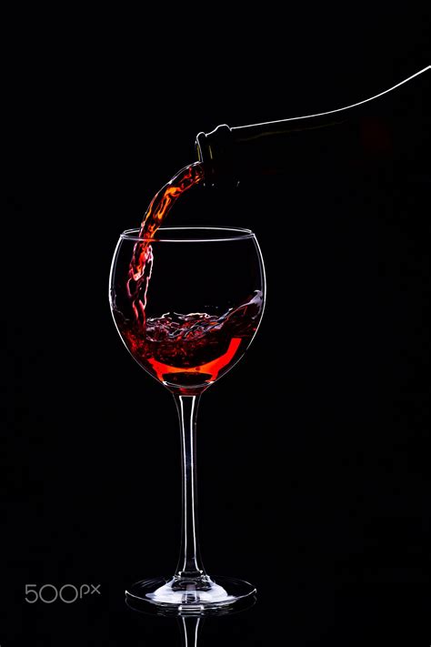 Red Wine In Wine Glasses And Wine Bottle On A Black Background