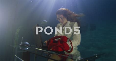 Cheerful Underwater Businesswoman Makes A Phone Call From Her Underwater Office Stock Footage