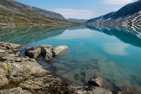 Landscape With Turquoise Lake Stones And Mountains Norway Stock Image