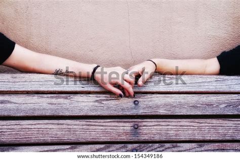 Two People Holding Hands On Bench Stock Photo Edit Now 154349186
