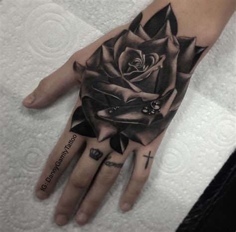Rose hand tattoo designs for women. Realistic Rose hand piece tattoo in black and grey on a ...