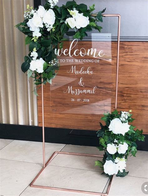 Glass Welcome Sign With Light Pink Flowers This Will Be Placed By