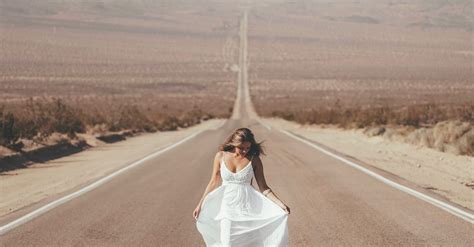 Unrecognizable Woman Walking Along Road In Countryside · Free Stock Photo