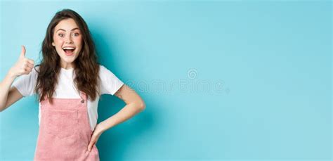 Portrait Of Surprised And Excited Brunette Girl Showing Thumb Up And