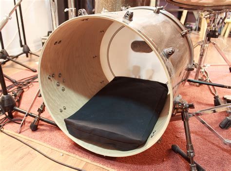 A pillow or blanket in the bass drum muffles the overtones. A custom bass drum muffling pillow with a hidden zipper