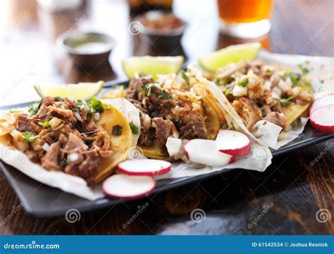Plate of Authentic Mexican Street Style Tacos with Radish Slices Stock
