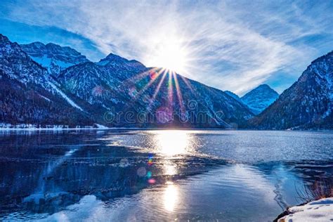 Frozen Lake On Mountain Forest Background At Sunrise Stock Image