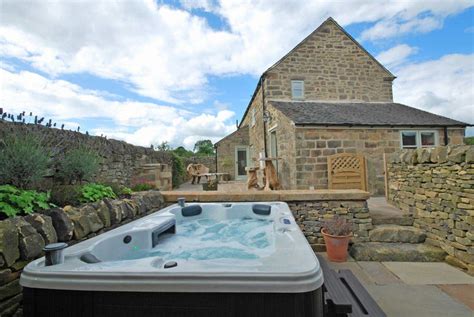 A Hot Tub Sitting In Front Of A Stone Building