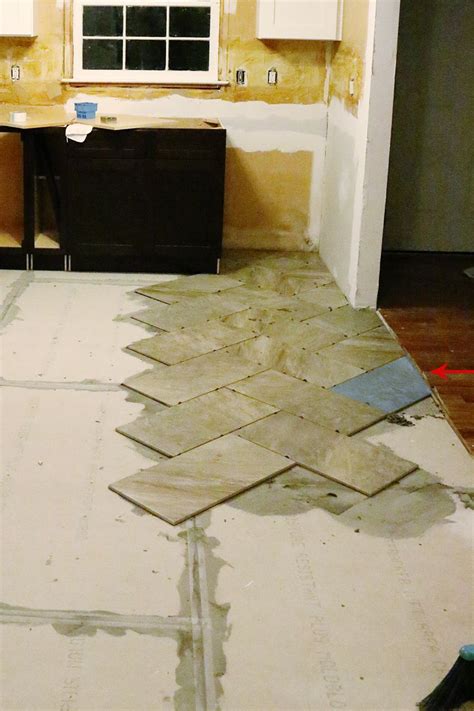An Unfinished Room With Tile Floors And Cabinets In The Process Of